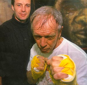 Businessman Roger Puckett, 62, prepares for the ring, under the watchful eye of trainer Paul Frediani